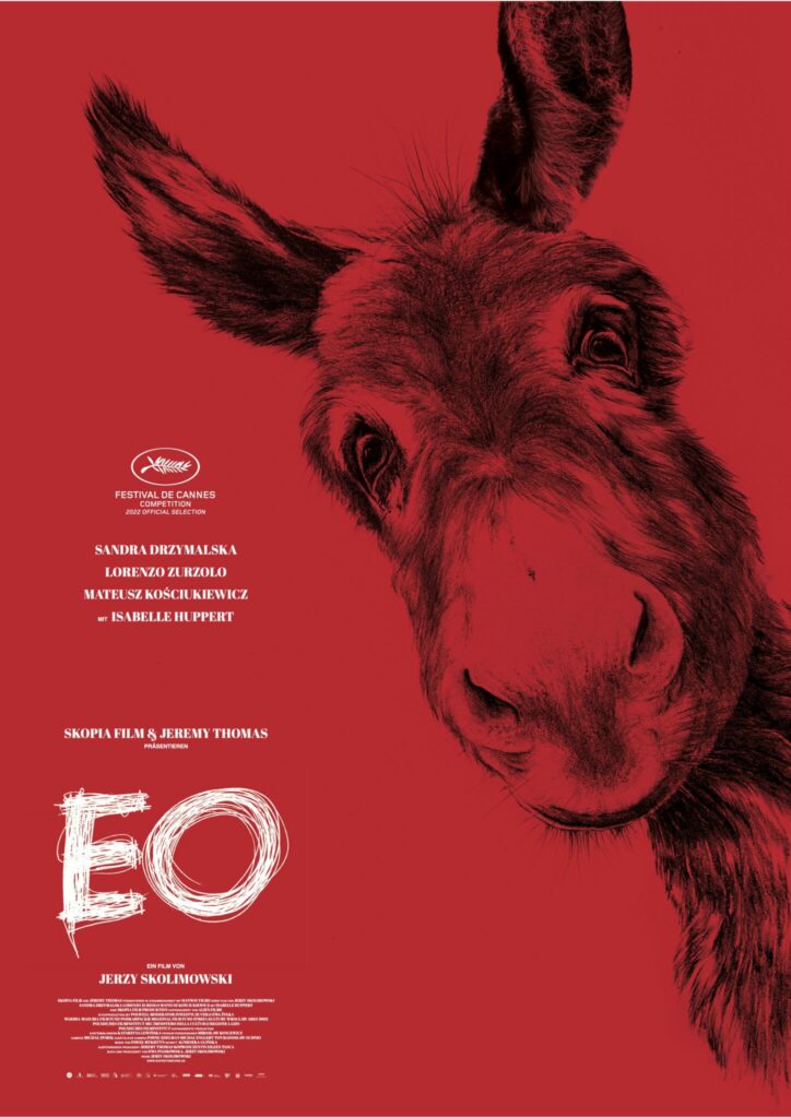 Auf dem Poster von EO, steht der Titel unten links unter den Namen der Schauspieler und Schauspielerinnen sowie dem Regisseur. Rechts daneben schaut uns Esel EO unverhohlen an. Nur sein Kopf ist auf dem Poster.