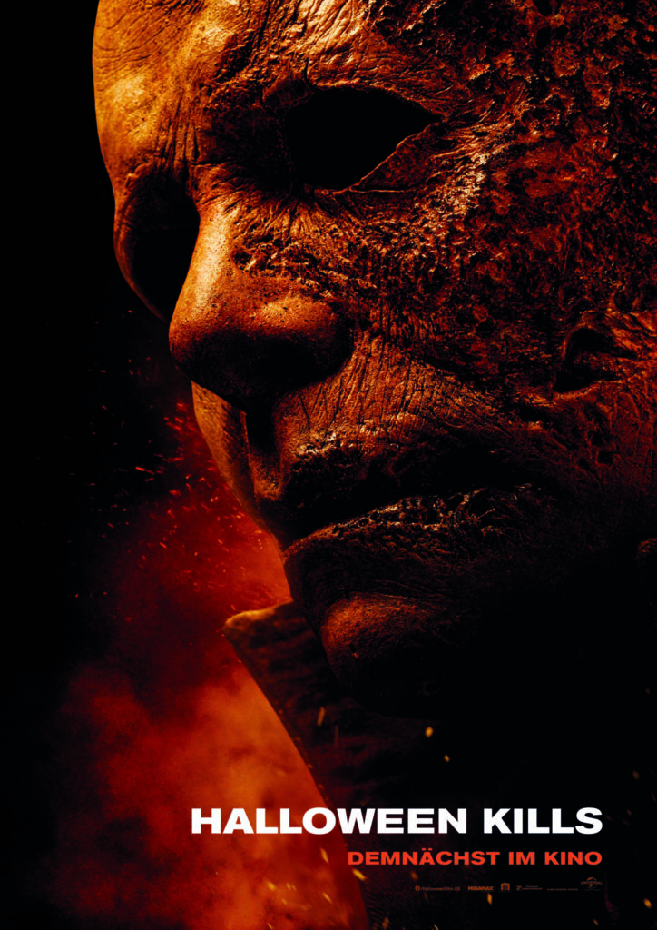 Das Filmposter zu Halloween Kills zeigt die verbrannte Maske von Michael Myers in der Nahaufnahme.