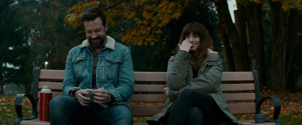 Jason Sudeikis und Anne Hathaway sitzen und reden in Colossal