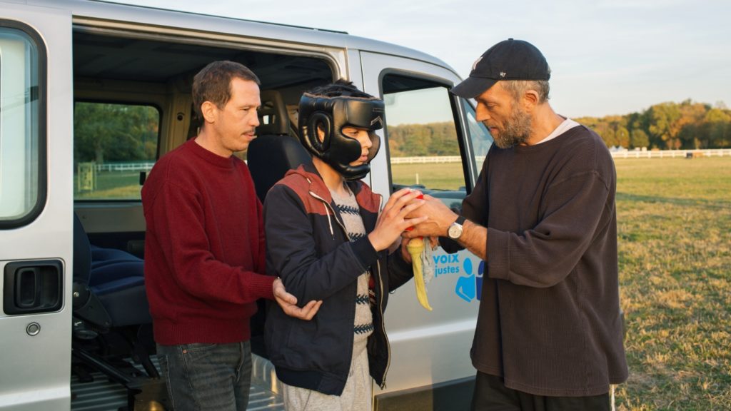 Malik (Reda Kateb) und Bruno (Vincent Cassel) stehen mit Valetin vor einem Van