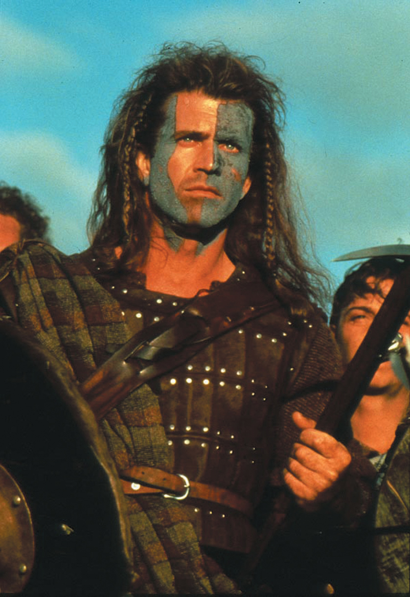 William Wallace (Mel Gibson) bereitet sich in Braveheart mit Kriegsbemalung und seiner schottischen Armee im Hintergrund auf die Schlacht gegen die Engländer vor - einer der besten Rachefilme.